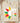 Sand ivory My History Is Strong shirt with red yellow green sunflower graphic folded on wood board