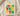 Cream Juneteenth t-shirt with bold 3x3 grid typography spelling JUNETEENTH in Pan-African green red yellow colors on Comfort Colors blank folded on wooden board