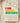 Cream Comfort Colors I Am Black History shirt with vibrant Pan-African typography and affirmation words folded on wooden board with soft blankets