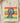 Sand cream Juneteenth celebration shirt with Black Father affirmation words in red yellow green folded on wood board
