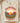 Retro desert sunset DTF transfer on natural shirt with Feel The Sunset text, radiating sun beams, cacti, barrel cacti, and yellow sunflowers in circular design