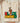 Cream Comfort Colors Black Owned shirt with crowned fist graphic breaking chains in Pan-African colors folded on wooden board with soft blankets