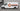 High-tack adhesive vinyl graphics applied to the side panel of a white commercial van