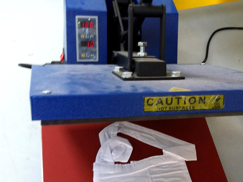 Swing-away heat press open over a white shirt. Photo by Scrud123, CC BY-SA 3.0.